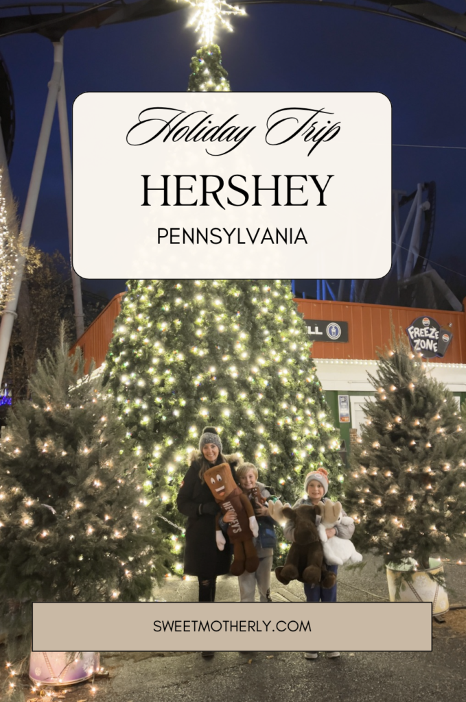 A family sitting under the christmas tree in front of hershey.